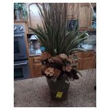 Flower arrangement in green vase.