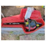 Homelite Chainsaw in case, and bottom of case has oil in it.