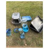 Grouping of cat litter and water containers.