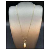 Elegant gold tone chain with teardrop pearl pendant