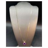 Elegant and dainty gold tone chain with gold tone over sterling pendant with amethyst-like and clear stones