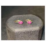 Pair of lever-back gold tone over sterling earrings with fuchsia colored stones