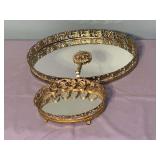 Very nice vintage ornately designed gold tone vanity set….larger tray is 13 x 9-1/2 x 1-1/2 tall…..smaller has lipstick slots and measures 7-1/2 x 5-1/2 x 1-1/2 tall…..mirror is 4” long
