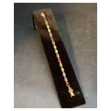 Stunning gold tone over sterling multi-color tennis bracelet….6-1/2”