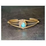 Silver toned smaller cuff bracelet with turquoise-like stone and leaf design