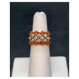 Gold tone over sterling ring with 2 outer rows of amber colored stones and silver design center…..size 5….4 grams