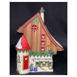 Dept. 56 North Pole Series Lighted Porcelain “Gift Wrap and Ribbons” Village Piece in original box…..7-1/4” tall