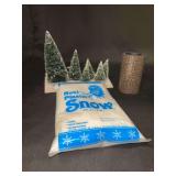 Grouping of various size village accessory snow capped trees, roll of cobblestone road and 1.5 oz. bag of plastic snow