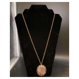 Elegant gold tone brown stone pendant/brooch combo with green rhinestone accent