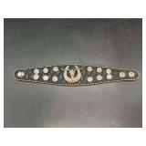 Black leather-like snap bracelet enhanced with multiple rhinestone accents and Longhorn/Horseshoe center