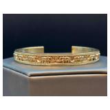 Beautiful gold tone cuff bracelet with lucky trunk-up elephant design