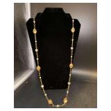 Elegant longer gold tone necklace with coral and white beaded accents
