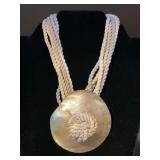 Nice looking soft multi-strand rope necklace with shell disc pendant