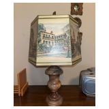 Table lamp with a multi-paneled shade featuring a watercolor-style illustration of a street scene with a marble-like base…..20” tall