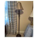 Traditional floor lamp featuring a dark bronze-like finish, metal scroll base with marble-like cylindrical accent and a beige flare shade….61” tall