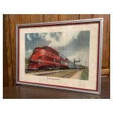 Framed print of early streamlined diesel locomotive used by the Chicago, Rock Island and Pacific Railroad. The train was known as "The Rocket”…..27-1/2 x 20-1/2