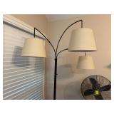 MCM arc floor lamp with a black metal frame and cream linen drum shades