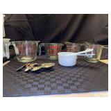 Assortment of glass measuring cups (1 PYREX, 1 Anchor Hocking and 2 unmarked), 3 white plastic and set of decorative metal measuring spoons