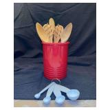 Red stoneware utensil crock, wooden utensils and set of Martha Stewart measuring spoons