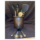 Vintage crock with kitchen utensils and measuring spoons