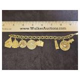 Beautiful Ladies 14K gold charm bracelet w/8 charms of various Ks(SEE PICS) 49.5 total grams...