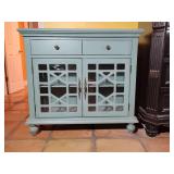 Coast to Coast Two Drawer Two Door Cupboard in distressed Teal finish. Good condition. Retails for $599.00. Located on 2nd floor. 36 1/2" T x 40" W x 12" D. Will have to be maneuvered around the stair