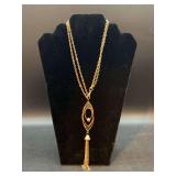 Gold Color double strand necklace with drop pendant featuring multiple oval rings and a tassel design