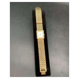 Nice looking gold-tone unisex wristwatch with a rectangular case and link bracelet…..no markings