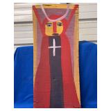 Authentic and original Mose T Folk Art depicting an angel wearing a religious robe and cross with signature soda can tab hanger…..9-5/8 x 22