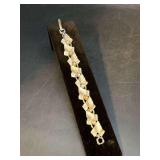 Vintage silvertone modernist link bracelet with a stylized leaf motif and pearl-like beads…..3 are missing