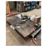 Motorcycle lift..Has a handmade wood piece sitting on top of this for four wheeler use. It is removable