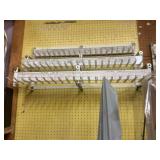 Set of three metal hanging display racks as shown. Buyer responsible for removal.