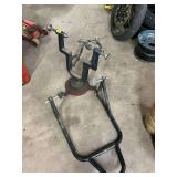 Motorcycle stand and a wheel truing stand