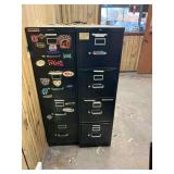 Two black metal four drawer file cabinets with enclosed manual as shown