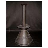 Antique early American capstan candlestick with a sand-filled base.  It features a wide, conical base and a tall, slender stem with a cup for holding a candle…..11-1/2” tall