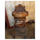 Antique Victorian convertible high chair, likely made of oak or walnut, which can transform into a stroller or rocking chair…..14”w x 23” deep x 36” tall