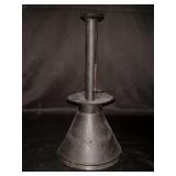 Antique early American capstan candlestick with a sand-filled base.  It features a wide, conical base and a tall, slender stem with a cup for holding a candle…..11-1/2” tall