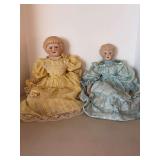 (2) vintage bisque cloth body porcelain arms/legs dolls, likely German or French in origin, dating from the late 19th or early 20th century