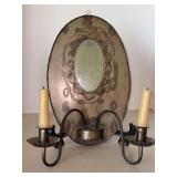 Vintage Pennsylvania Dutch wall sconce/mirror featuring a distressed oval mirror framed in metal with integrated candleholders, resembling a farmhouse look…..11w x 14 tall