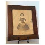 Framed print depicts a 19th-century American folk art watercolor print of a young girl, likely dating to around 1830-1850…..14-1/4 x 16-3/4
