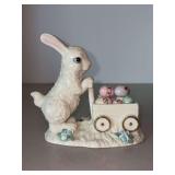 Lenox Store Exclusive porcelain figurine depicting a white Easter Bunny pushing a cart filled with colorful Easter eggs…..5-1/2” long x 5-1/4” tall
