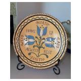 Pennsylvania Dutch (Wisconsin Pottery) decorative ceramic plate styled after American folk art, specifically Pennsylvania German redware, featuring floral designs and a rustic motto