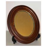 Aged wood framed oval mirror…..11 x 13