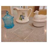 Vintage white ceramic 'hen on nest' baking dish or tureen. Vintage Fostoria Blue Coin Glass candy jar with a lid, featuring impressed coin designs on the base and lid. Vintage large ceramic pitcher fr