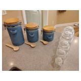 3 Honeybloom ceramic canister set featuring wooden lids and spoons, 5 Vintage clear glass apothecary jars, starburst-patterned lids. Smallest one has screw on plastic lid.
