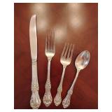 Sterling 'Wild Rose' pattern 4 piece place setting, knife, dinner fork, salad fork, dinner spoon. Weighs 114 grams.