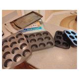 Cookie Sheets 3, Muffin Pans 4, Oven Rack Liner 1. Bottom cookie sheet Mirror, 12 muffin pans Wilton. 8 Pieces.