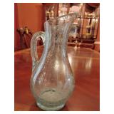 Hand-blown art glass pitcher, controlled bubble texture with a green tint, decorative etching, 9 3/4' T, apprx. 5' across.