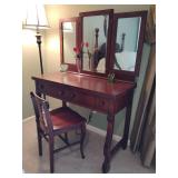 Antique dressing table featuring a mahogany finish and a tri-fold mirror system, beveled mirror, 2 upper drawers, with mirror 58 1/2'T, table 31' T x 42' W x 19 1/2' D. Some nicks & chips. Other conte