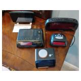 collection of vintage digital alarm clocks and clock radios, including models from GPX and General Electric. These items are categorized as collectibles due to their age and decorative appeal. All unt